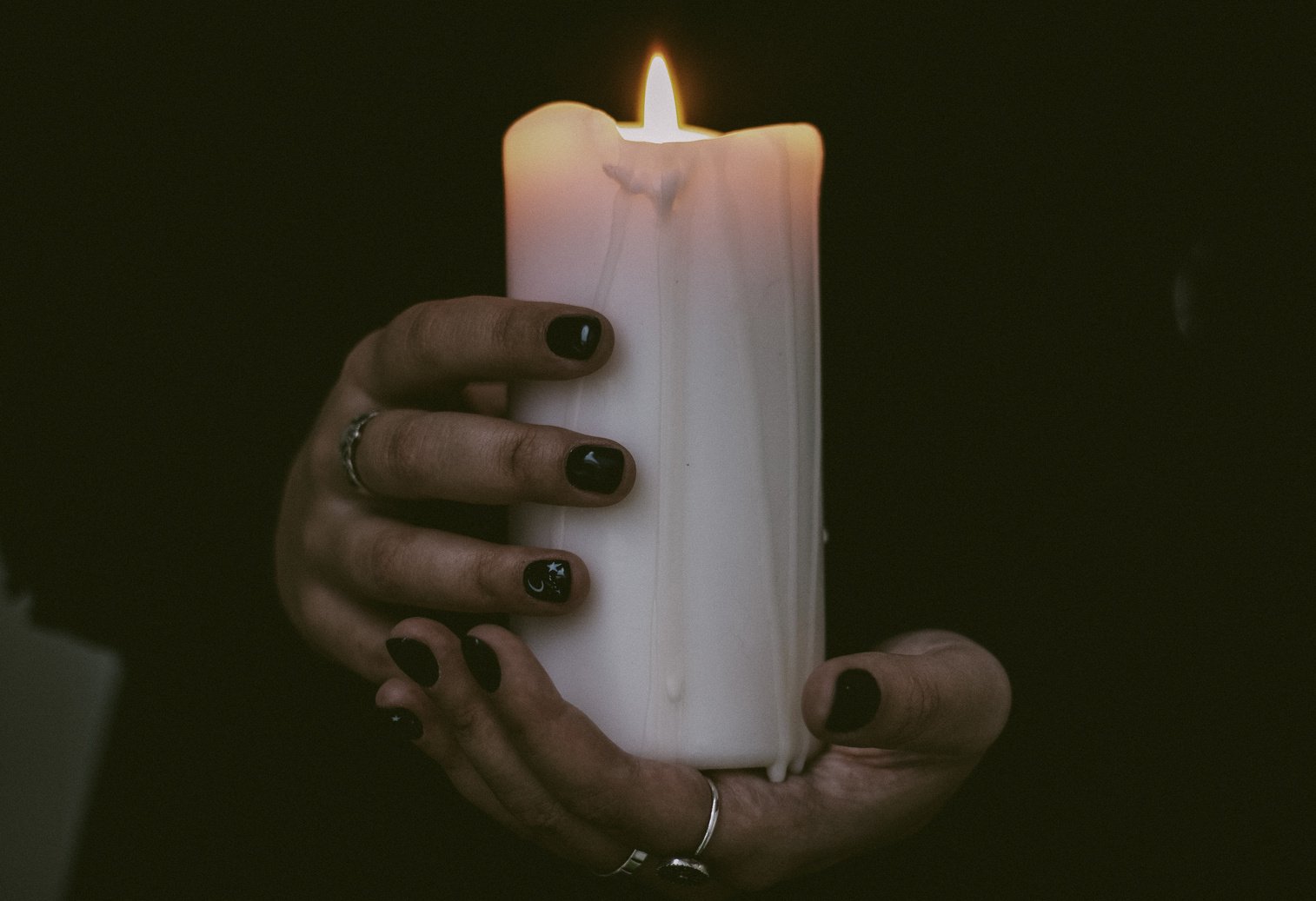  A Close-Up Shot of a Person Holding a Lighted Candle